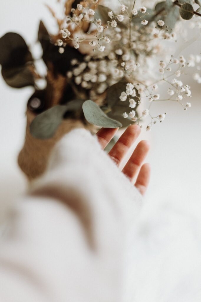 branding-identity-service-image-hand-reaching-to-dried-eucalyptus-in-white-vase.jpg