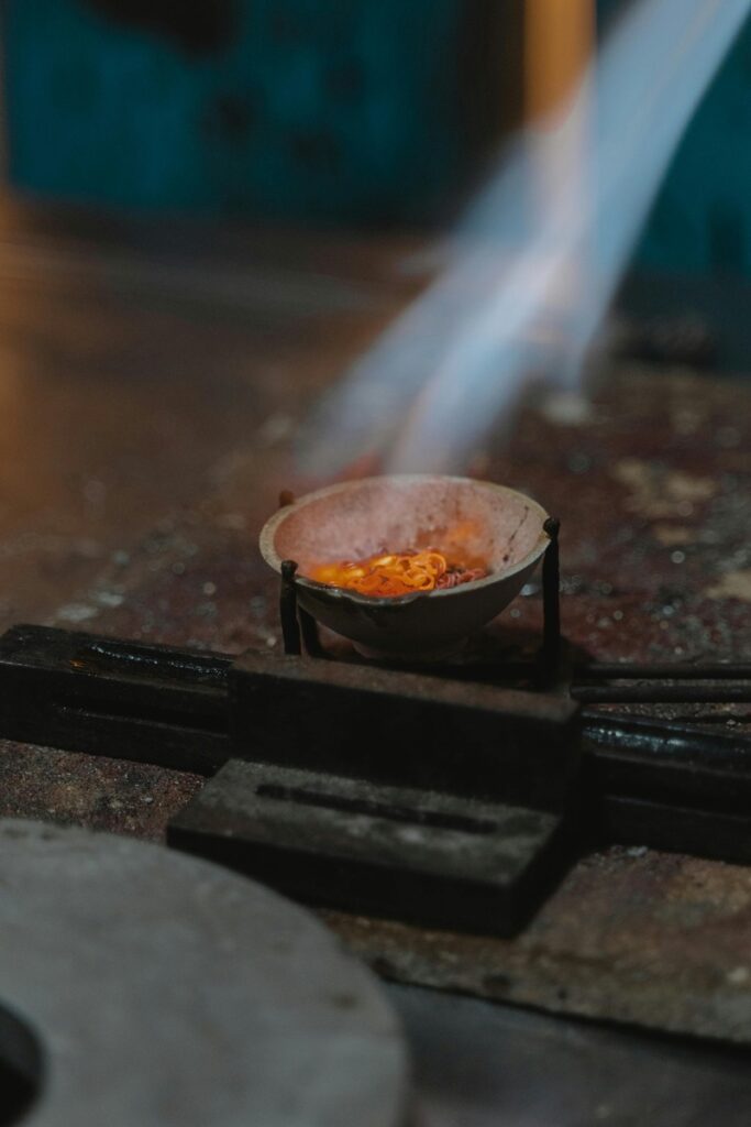 lost wax casting melting metal with flame in casting bowl